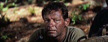 Movie still from “The Bridge on the River Kwai” (1957), directed by David Lean – A person wearing a sweater; Close Up shot, Low angle