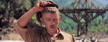 Movie still from “The Bridge on the River Kwai” (1957), directed by David Lean – An older man with a hat on his head; Close Up shot, Low angle