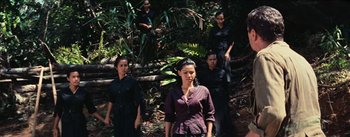 Movie still from “The Bridge on the River Kwai” (1957), directed by David Lean – A group of people standing in the forest; Wide shot, High angle