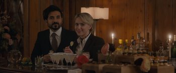 Movie still from “The Bubble” (2022), directed by Judd Apatow – A man and a woman sitting at a dinner table; Medium shot, Over the shoulder angle