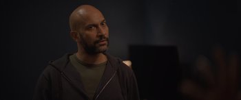 Movie still from “The Bubble” (2022), directed by Judd Apatow – A man with a bald head looking to his left; Close Up shot, Over the shoulder angle