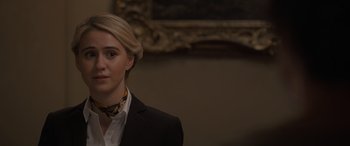 Movie still from “The Bubble” (2022), directed by Judd Apatow – A woman with blonde hair wearing a black suit; Close Up shot, Over the shoulder angle