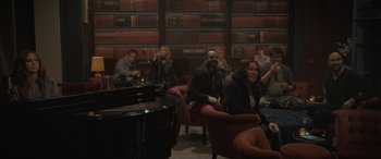 Movie still from “The Bubble” (2022), directed by Judd Apatow – A group of people sitting around a room; Wide shot, High angle