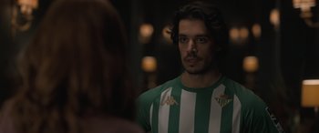 Movie still from “The Bubble” (2022), directed by Judd Apatow – A person wearing a green and white shirt; Close Up shot, Over the shoulder angle