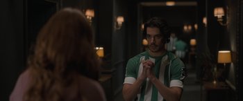 Movie still from “The Bubble” (2022), directed by Judd Apatow – A man in a green and white striped shirt looking at a woman in a green and white striped shirt; Medium shot, Over the shoulder angle