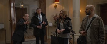 Movie still from “The Bubble” (2022), directed by Judd Apatow – A man and a woman standing next to each other in a room; Medium shot, Over the shoulder angle