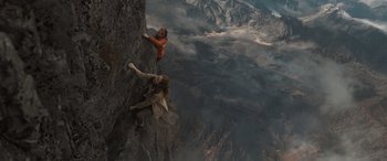 Movie still from “The Bubble” (2022), directed by Judd Apatow – Two people are climbing a rock wall in the mountains; Extreme Wide shot, Overhead angle
