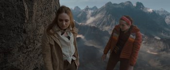 Movie still from “The Bubble” (2022), directed by Judd Apatow – A woman standing next to a man on top of a mountain; Medium shot, Low angle