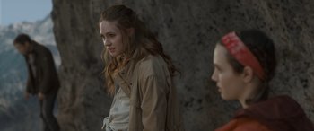 Movie still from “The Bubble” (2022), directed by Judd Apatow – A woman in a tan jacket standing next to another woman in a tan jacket; Close Up shot, Over the shoulder angle