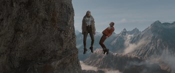 Movie still from “The Bubble” (2022), directed by Judd Apatow – Two people are jumping off a cliff; Wide shot, Low angle