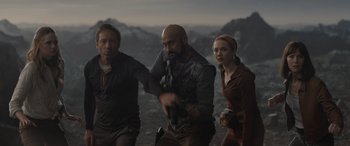 Movie still from “The Bubble” (2022), directed by Judd Apatow – A group of people standing next to each other on top of a hill; Medium shot, Low angle