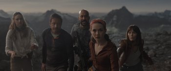 Movie still from “The Bubble” (2022), directed by Judd Apatow – A group of people standing next to each other; Medium shot, Over the shoulder angle