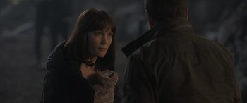 Movie still from “The Bubble” (2022), directed by Judd Apatow – A woman standing next to a man in a dark room; Close Up shot, Over the shoulder angle
