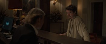 Movie still from “The Bubble” (2022), directed by Judd Apatow – A man is looking in the mirror while a woman looks at him; Medium shot, Over the shoulder angle