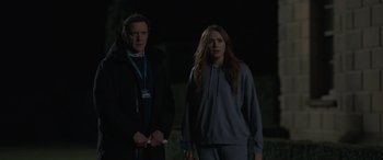 Movie still from “The Bubble” (2022), directed by Judd Apatow – A man and a woman standing next to each other in the dark; Medium shot, Over the shoulder angle
