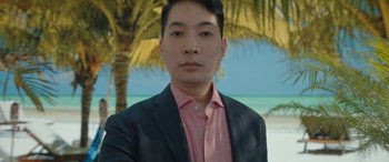 Movie still from “The Bubble” (2022), directed by Judd Apatow – A man wearing a suit and a pink shirt; Medium shot, Low angle
