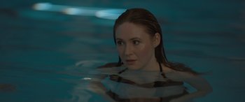 Movie still from “The Bubble” (2022), directed by Judd Apatow – A beautiful young woman in a pool of water; Close Up shot, Over the shoulder angle