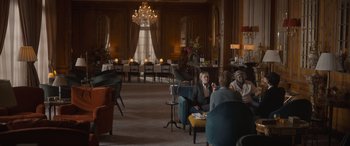 Movie still from “The Bubble” (2022), directed by Judd Apatow – People are sitting in chairs in a large room; Wide shot, Over the shoulder angle