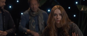 Movie still from “The Bubble” (2022), directed by Judd Apatow – A woman with long red hair sitting in front of a man; Close Up shot, Over the shoulder angle