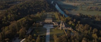 Movie still from “The Bubble” (2022), directed by Judd Apatow – An aerial view of a large mansion with a lake in the background; Extreme Wide shot, High angle