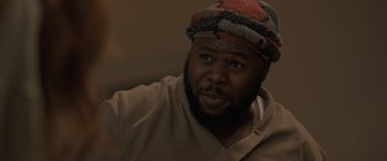 Movie still from “The Bubble” (2022), directed by Judd Apatow – A person wearing a hat; Close Up shot, Low angle