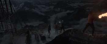 Movie still from “The Bubble” (2022), directed by Judd Apatow – A group of people walking across a bridge; Extreme Wide shot, High angle