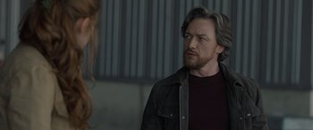 Movie still from “The Bubble” (2022), directed by Judd Apatow – A man with long hair and a beard looking at a woman; Close Up shot, Over the shoulder angle