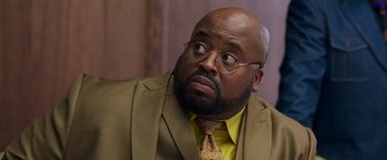 Movie still from “The Burial” (2023), directed by Maggie Betts – A man in a suit and tie looking up at the sky; Close Up shot, Over the shoulder angle