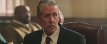 Movie still from “The Burial” (2023), directed by Maggie Betts – An older man in a suit and tie looking to his left; Close Up shot, Low angle