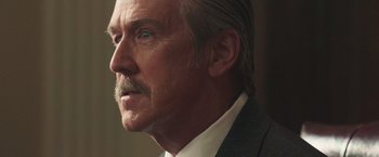 Movie still from “The Burial” (2023), directed by Maggie Betts – An older man wearing a white shirt and a suit; Close Up shot, Low angle