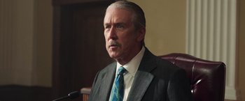 Movie still from “The Burial” (2023), directed by Maggie Betts – An older man in a suit and a tie; Close Up shot, Low angle