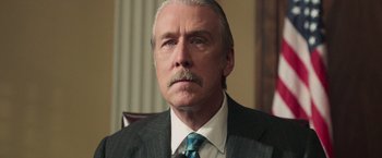 Movie still from “The Burial” (2023), directed by Maggie Betts – An older man in a suit and tie looking into the distance; Close Up shot, Low angle