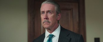 Movie still from “The Burial” (2023), directed by Maggie Betts – An older man with a mustache wearing a suit and tie; Close Up shot, Low angle