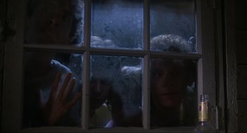 Movie still from “The Burning” (1981), directed by Tony Maylam – Two people looking out of a window at night; Close Up shot, Low angle