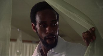 Movie still from “The Burning” (1981), directed by Tony Maylam – A person wearing a white shirt; Close Up shot, Low angle
