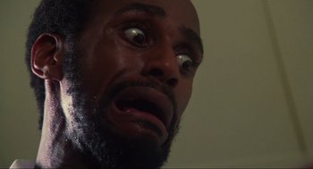 Movie still from “The Burning” (1981), directed by Tony Maylam – A man's face with a surprised look on his face; Extreme Close Up shot, Low angle