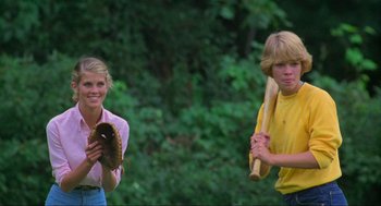 Movie still from “The Burning” (1981), directed by Tony Maylam – A woman holding a baseball glove and a boy holding a baseball bat; Medium shot, Over the shoulder angle