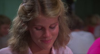 Movie still from “The Burning” (1981), directed by Tony Maylam – A person with long hair and wearing a pink shirt; Close Up shot, Over the shoulder angle