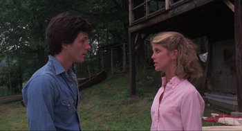 Movie still from “The Burning” (1981), directed by Tony Maylam – A man and a woman talking to each other outside; Medium shot, Low angle