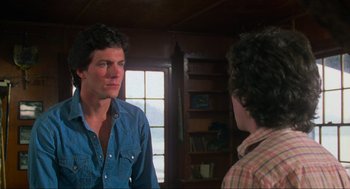 Movie still from “The Burning” (1981), directed by Tony Maylam – Two men are talking in a living room; Close Up shot, Over the shoulder angle