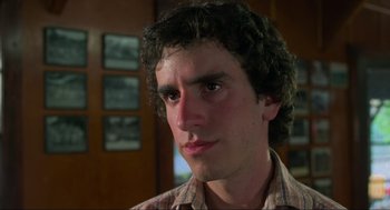 Movie still from “The Burning” (1981), directed by Tony Maylam – A young man with curly brown hair stares into the camera; Close Up shot, Low angle