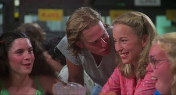 Movie still from “The Burning” (1981), directed by Tony Maylam – A man and a woman sitting next to each other at a table; Close Up shot, Over the shoulder angle