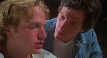Movie still from “The Burning” (1981), directed by Tony Maylam – Two young men looking at each other in a room; Close Up shot, Low angle