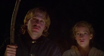 Movie still from “The Burning” (1981), directed by Tony Maylam – A man and a woman standing next to each other in the dark; Close Up shot, Low angle