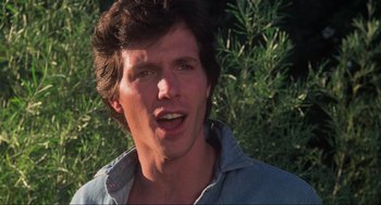 Movie still from “The Burning” (1981), directed by Tony Maylam – A person wearing a blue shirt; Close Up shot, Low angle