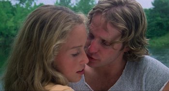 Movie still from “The Burning” (1981), directed by Tony Maylam – A man and a woman face to face with trees in the background; Close Up shot, Low angle