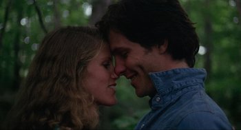 Movie still from “The Burning” (1981), directed by Tony Maylam – A man and a woman kissing in a wooded area; Close Up shot, Low angle