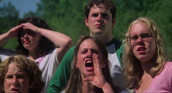 Movie still from “The Burning” (1981), directed by Tony Maylam – A group of young people standing around one another; Medium shot, Low angle