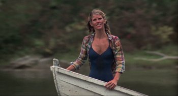 Movie still from “The Burning” (1981), directed by Tony Maylam – A woman standing on the side of a boat in a body of water; Medium shot, Low angle