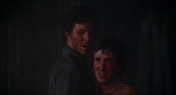 Movie still from “The Burning” (1981), directed by Tony Maylam – Two men standing next to each other in the dark; Close Up shot, Low angle